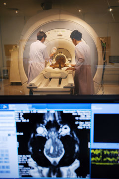 veterinarian doctor working in MRI room with moniter foreground