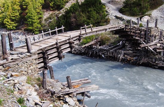 Wooden foot bridge over a glacial river, Himalayas, Nepal
