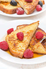 delicious French toast with raspberry and maple syrup, vertical