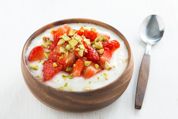 dessert of yogurt with strawberries and pistachios
