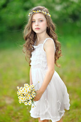 portrait of a beautiful little girl with chamomile