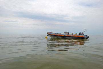 Naklejka na ściany i meble Motorboat floating at sea in summer