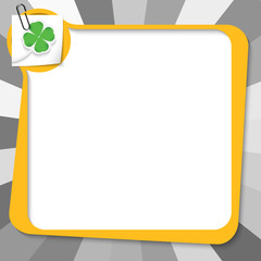 yellow text box with paper clip and cloverleaf