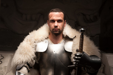 Medieval warrior in armor and fur mantle