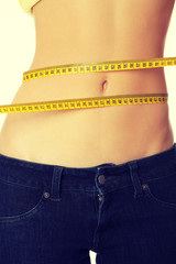 Slim woman's body with measuring tape.