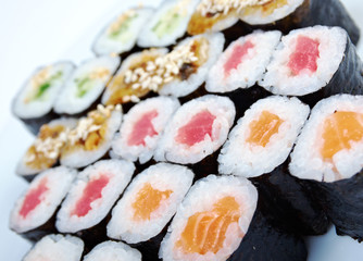 Roll made salmon, eel, tuna, vegetables