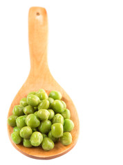 Green peas on wooden spoon over white background