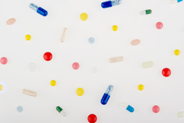Color pills and capsules background isolated on white background