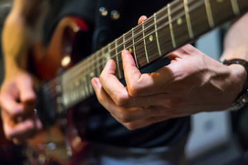 musician plays a guitar