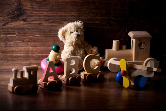 collection of old wood children toys with teddy bear