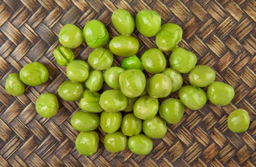 Green peas on wicker background