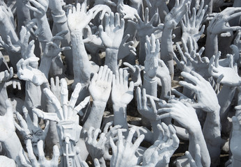 Hands of the underworld's most merit at the temple, Thailand.