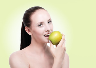 beautiful woman eating a green apple