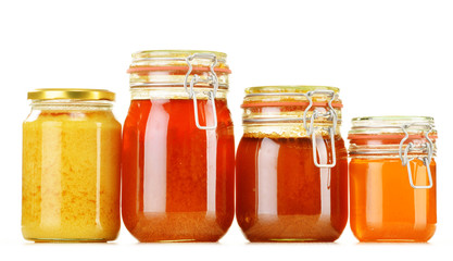 Composition with jar of honey isolated on white