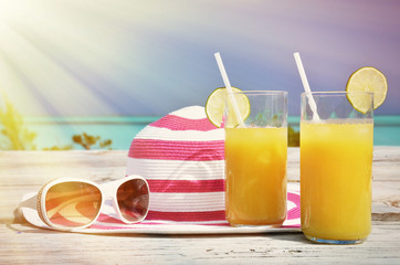 Sunglasses, hat and orange juice