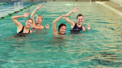 Fit women doing aqua aerobics in the pool