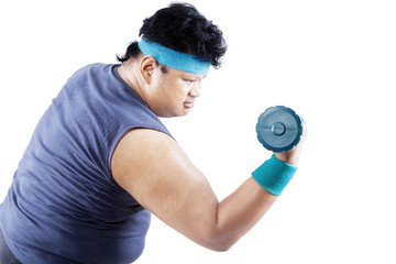 Overweight man exercising with dumbbell 1