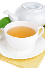 Cup of tea with jasmine on table close-up