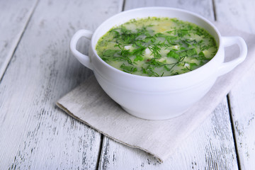 Delicious green soup with sorrel on table close-up