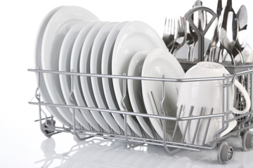 Clean dishes drying on metal dish rack, isolated on white