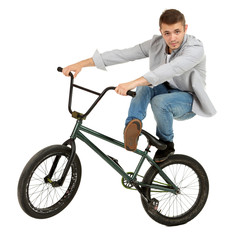 Young boy on BMX bike isolated on white