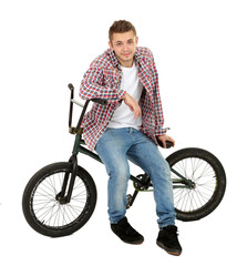 Fototapeta na wymiar Young boy on BMX bike isolated on white