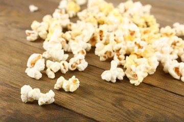 Popcorn on wooden table, close up