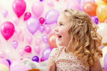 Obraz na płótnie Canvas Adorable cheerful girl on balloons background