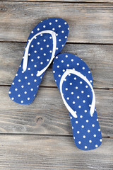 Color flip-flops on wooden background