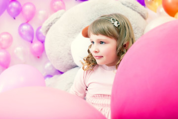 Obraz na płótnie Canvas Portrait of lovely little girl posing in playroom