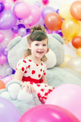 Fototapeta na wymiar Image of merry little girl posing in playroom