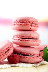 Gentle macaroons on table on light background