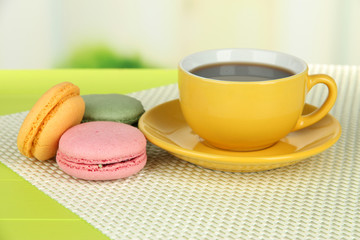 Fototapeta na wymiar Coffee and macaroons on table on light background