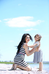 Happy mom and daughter. Walk on the beach