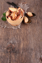 Tasty brasil nuts on wooden background