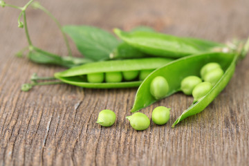 Fresh green peas on wooden table