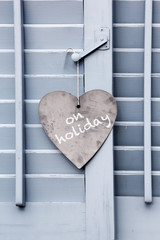 On holiday sign in heart shape on closed window