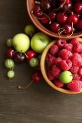 Fototapeta na wymiar Fresh berries in bowls, close up