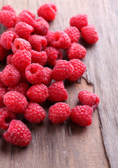 Ripe sweet raspberries on table close-up