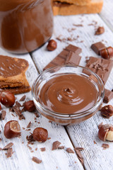 Sweet chocolate cream in bowl on table close-up
