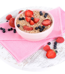Tasty oatmeal with berries isolated on white