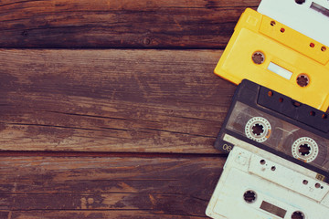 Cassette tapes over wooden table. top view.  