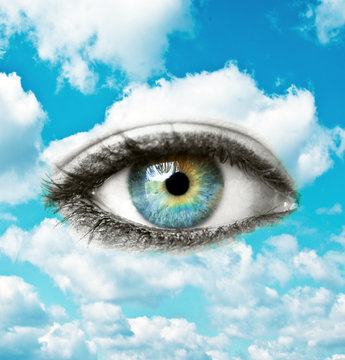 Beautiful blue human eye with bright sky - Spiritual concept