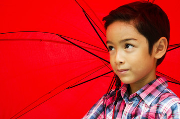 Little boy taking an umbrella