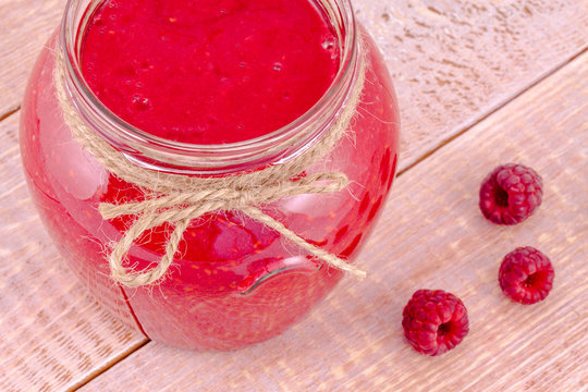 Raspberry Smoothie on rustic wooden table