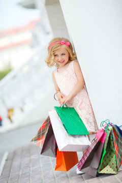 Little girl fashion with packages at the Mall.