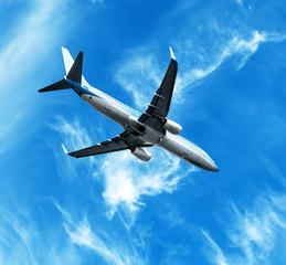 Fototapeta na wymiar Big jet plane flying against perfect sky background