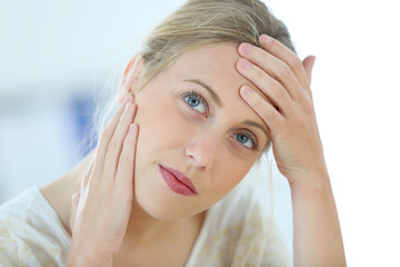 Beautiful blond woman having a headache