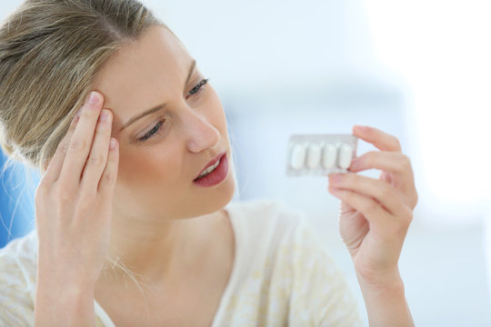 Beautiful blond woman having a headache