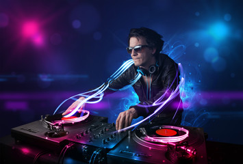Disc jockey playing music with electro light effects and lights